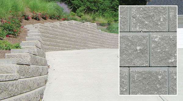 Close-up of Allan Block grey blocks used to build a driveway