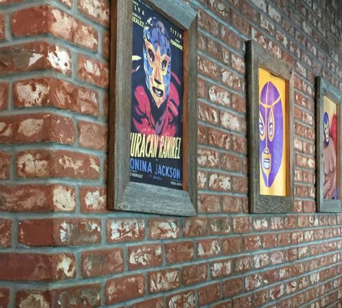 Wall made with McNear Bricks and decorated with Lucha Libre posters