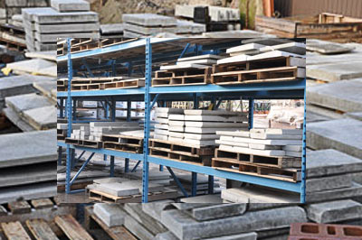 Metal industrial storage rack with pre-cast concrete blocks