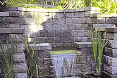 Artificial cascade made by Cypress Stone retaining wall