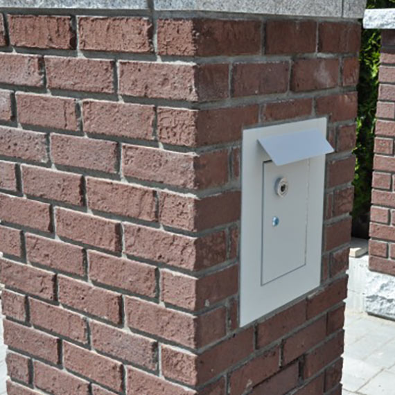 Aluminium mailbox built into brick post